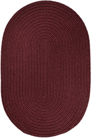Solid Poly Burgundy braided indoor/outdoor rug by Rhody Rug — oval